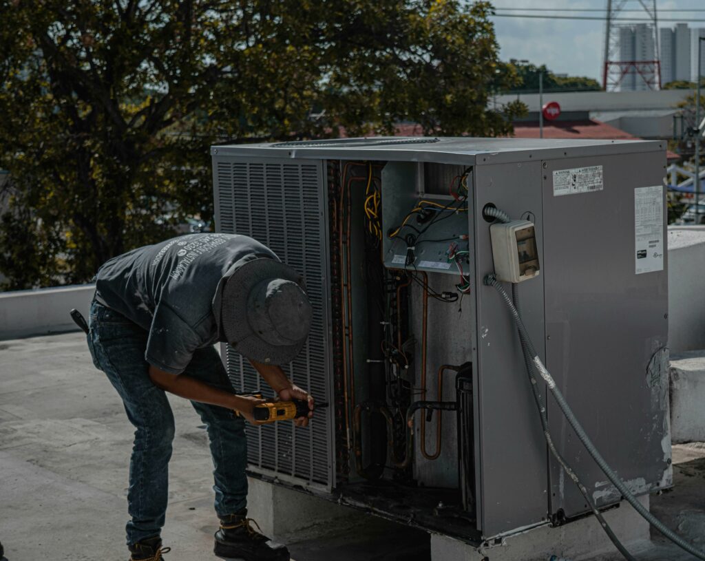 HVAC technician fixing air conditioning unit for residential repair services in DFW